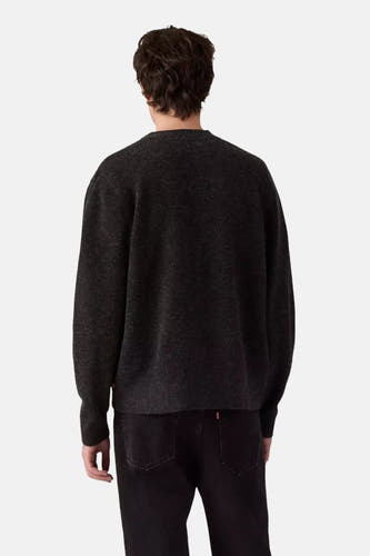 Gilet tricoté gris de Levi's, vue arrière, associé à des jeans noirs avec un badge de marque rouge.