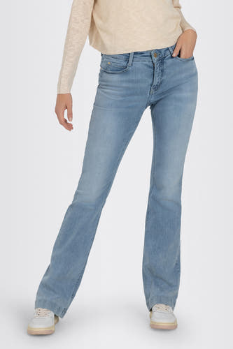 Jean bootcut bleu clair de MAC, avec détail de poche et une main visible.