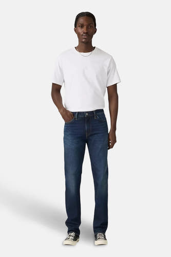 Jean slim fit bleu marine de Levi's, avec un T-shirt blanc et des baskets noires.