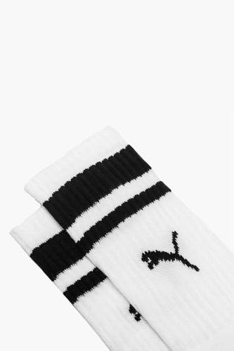 Witte sokken van PUMA met zwarte strepen aan de bovenkant en een zwart logo.