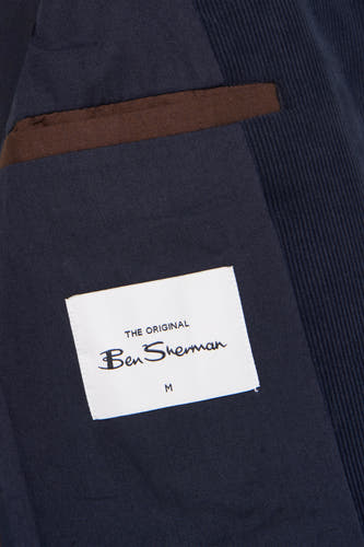 Blazer bleu de BEN SHERMAN, avec des accents marrons sur les poches et une étiquette de taille visible.