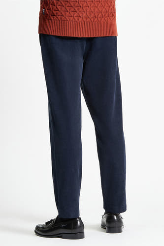 Pantalon bleu de BEN SHERMAN, avec une fine texture en velours côtelé, associé à des chaussures noires en cuir.