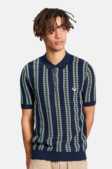 Blauwe polo van Ben Sherman met verticale strepen in groen en wit, korte mouwen en een klassieke kraag.