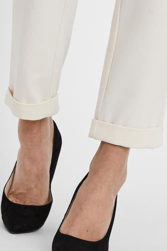 Pantalon costum beige de VERO MODA®, avec des poches à rabat et porté avec des escarpins noirs.