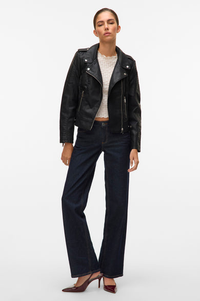 Zwarte leren jas van Vero Moda, met zilverkleurige ritssluitingen, gedragen met donkere jeans en bordeauxrode hakken.
