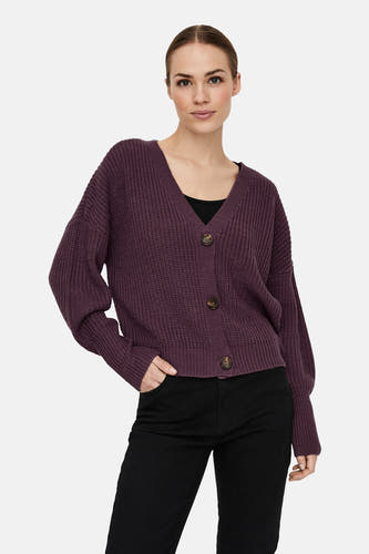 Cardigan marron de VERO MODA avec fermeture à boutons et longues manches, porté sur une chemise noire et un pantalon.
