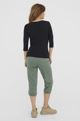 T-shirt noir à manches longues de VERO MODA, vu de dos, associé à un pantalon vert et des chaussures beige.
