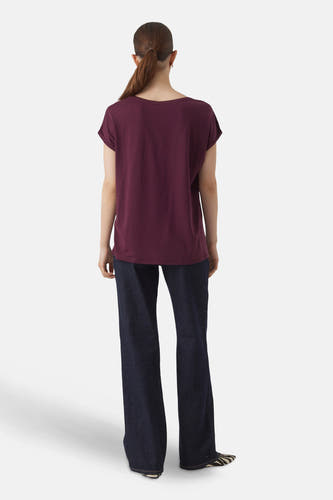 T-shirt violet à manches courtes de VERO MODA, vu de dos, associé à des jeans foncés et des chaussures à imprimé zèbre.