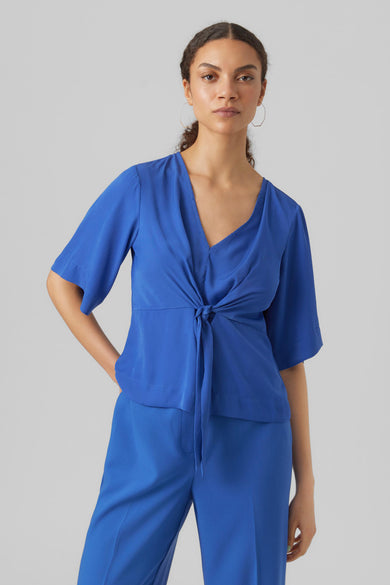 Blouse bleue à manches trois-quarts de VERO MODA, vue de derrière, associée à un pantalon et des chaussures coordonnés.