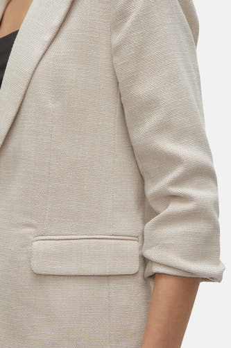 Blazer écru de VERO MODA, coupé sur une personne portant un haut noir en dessous.