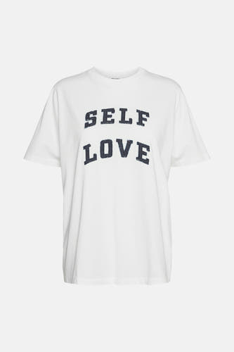 T-shirt blanc à manches courtes de VERO MODA®, avec l'inscription "Self Love" en lettres foncées.