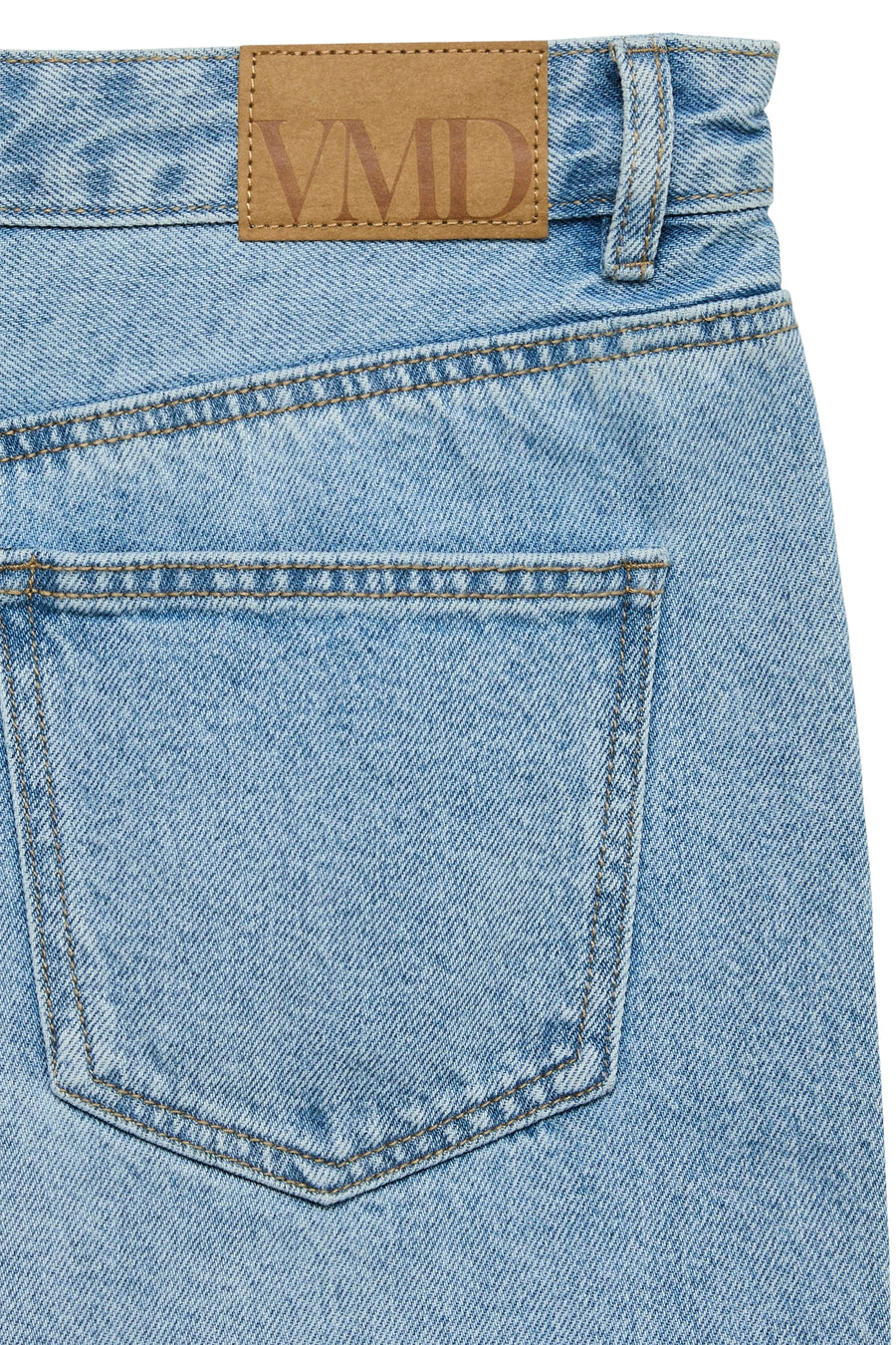 Short en jean bleu clair de VERO MODA avec coutures apparentes et un logo marron 'VMD' sur la ceinture.