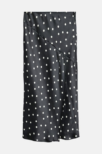 Longue jupe noire de VERO MODA® avec des taches blanches et une fente à l'avant.