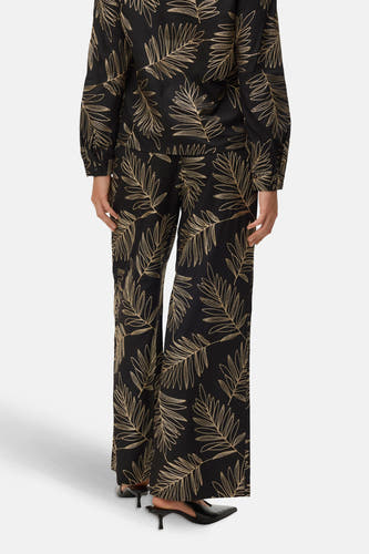 Zwarte broek van VERO MODA® met gouden palmbladmotief, losse pasvorm en wijde pijpen.