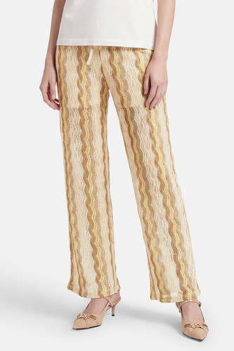 Pantalon multicolore de VERO MODA® avec des rayures ondulées dans des tons beiges et jaunes, en maille ajourée.