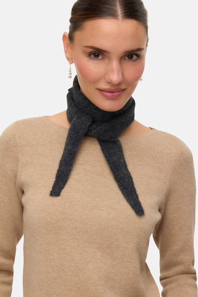 Chapeau d'été gris de VERO MODA, porté autour du cou comme accessoire, associé à une chemise beige et des boucles d'oreilles argentées.