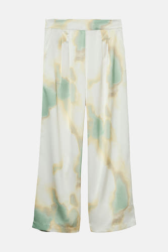 Pantalon multicolore de VERO MODA® avec motif tie-dye vert, jaune et blanc, gros plan du tissu avec taille élastique.
