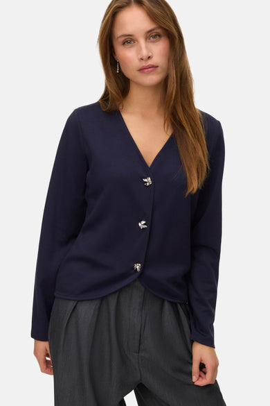 Gilet bleu de VERO MODA, avec des manches longues et des boutons décoratifs argentés.