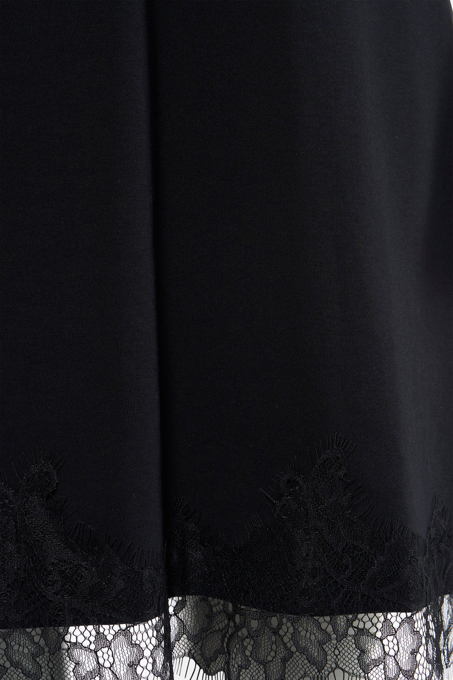 Robe courte noire à manches courtes de VERO MODA® avec ourlet en dentelle et détails transparents.