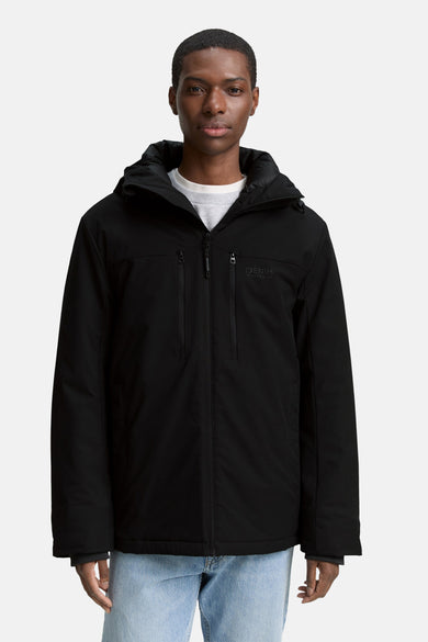 Manteau court noir de TOM TAILOR, avec capuche, fermeture éclair et deux poches, porté sur un t-shirt blanc et un jean bleu.