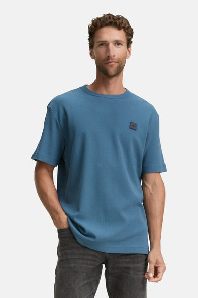 T-shirt bleu à manches courtes de TOM TAILOR, avec une subtile texture et un logo carré sur la poitrine.