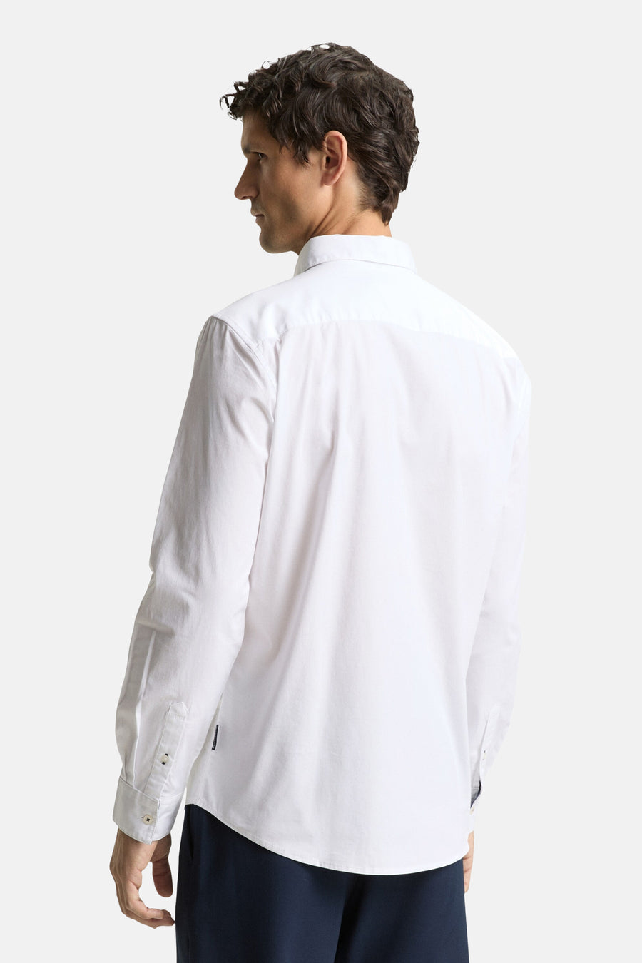 Chemise blanche à manches longues de TOM TAILOR, vue de derrière, avec un pantalon foncé.