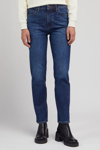 Blauwe jeans met rechte pijpen en zwarte laarzen.
