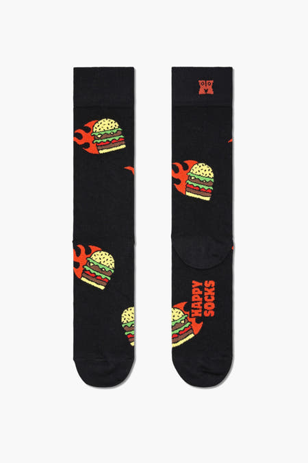 Chaussettes noires de Happy Socks avec un motif de hamburger et de flamme répété.