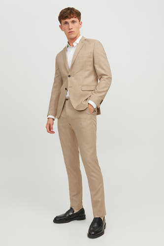 Beige kostuumbroek van PREMIUM by JACK & JONES, gecombineerd met een wit overhemd en zwarte loafers.