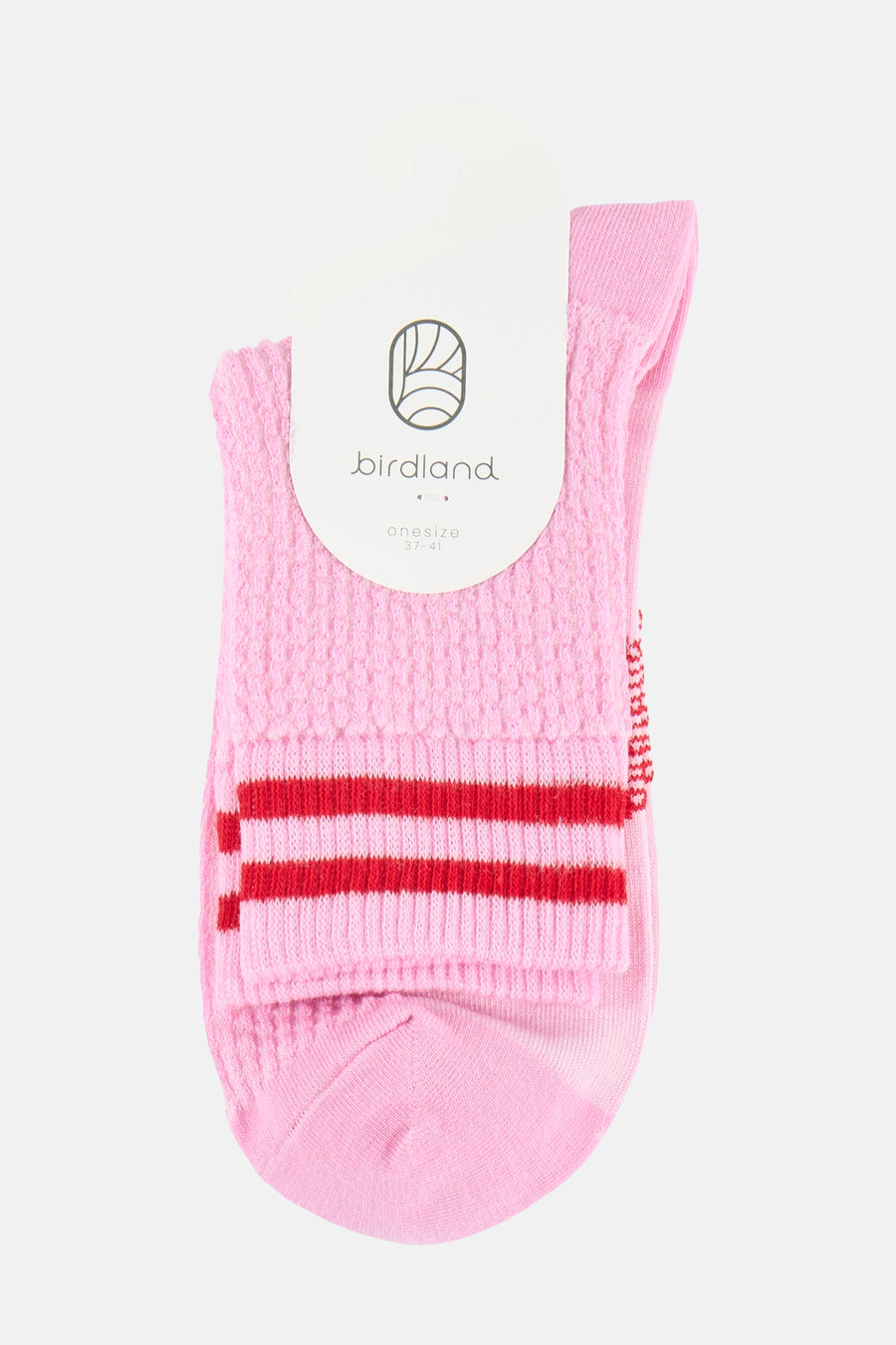 Chaussettes roses BIRDLAND avec une texture tricotée, deux rayures rouges et une étiquette blanche.