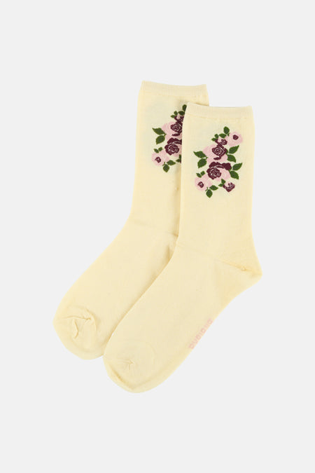 Chaussettes tricotées de couleur crème BIRDLAND avec imprimé rose dans des tons de rose, suspendues à un cintre blanc avec 'taille unique 37-41'.