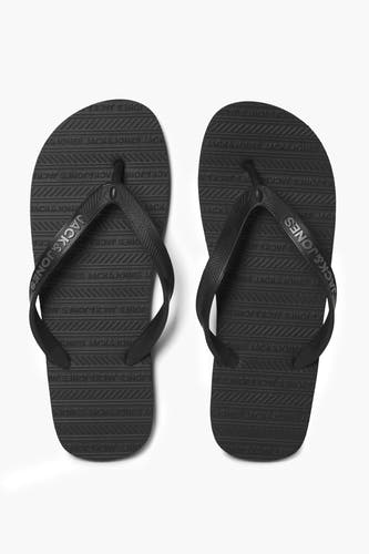 Chaussons noirs d'ACCESSORIES BY JACK & JONES, avec un motif logo et une texture sur toute la chausson.