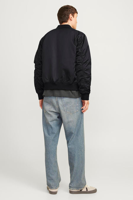 Blouson aviateur noir de CORE BY JACK & JONES, dos avec manches froncées, porté avec un pull gris et un jean bleu