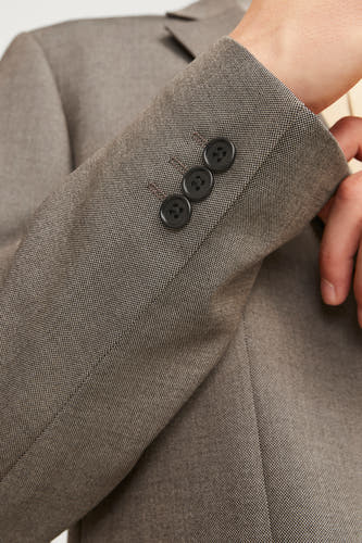 Blazer gris de PREMIUM par JACK & JONES, avec trois boutons sur la manche et une subtile texture.