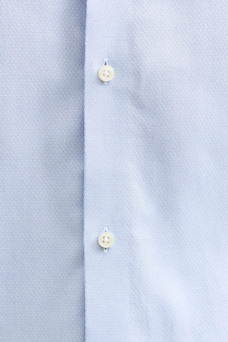 Bleu, chemise à manches longues de PREMIUM by JACK & JONES, avec une subtile texture et des boutons blancs.