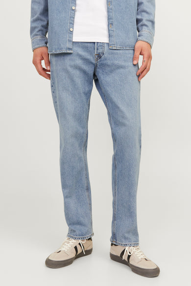 Jean tapered bleu clair de JACK & JONES JEANS INTELLIGENCE, associé à un t-shirt denim et des baskets beige.