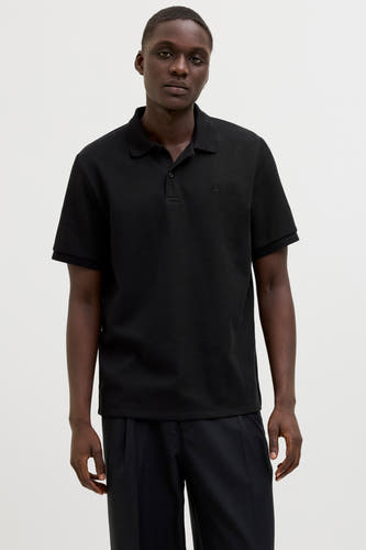 Polo noir à manches courtes de CORE BY JACK & JONES, avec une texture tissée et un col classique.