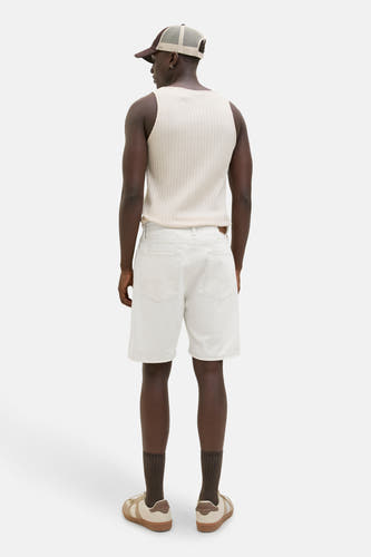 Jean écru court de JACK & JONES JEANS INTELLIGENCE, avec des poches arrière, associé à un t-shirt et des baskets.