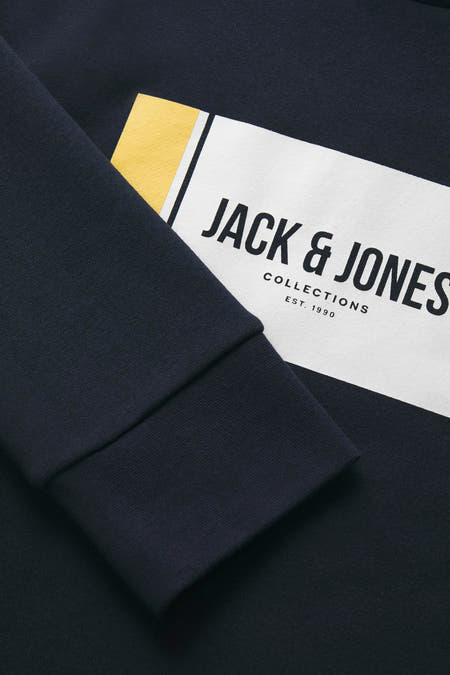 Gilet bleu avec col rond de CORE BY JACK & JONES, détail de la manche avec logo.