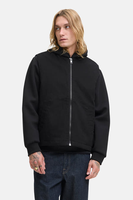 Gilet chauffeuse noir de PREMIUM BLUE par JACK & JONES, avec des manches longues et une fermeture éclair argentée.