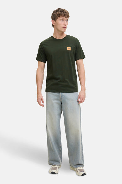 T-shirt vert de mantes courtes manSS BY JACK & J J, un petit petit logo sur sur po et associéé des jeans larges.