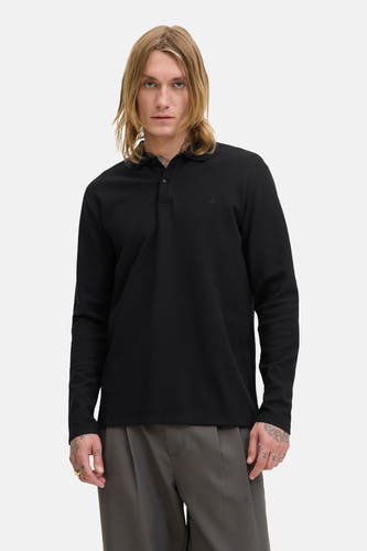 Sweat-shirt noir à col V de PREMIUM BLUE par JACK & JONES, texture fine visible et porté avec un pantalon gris.