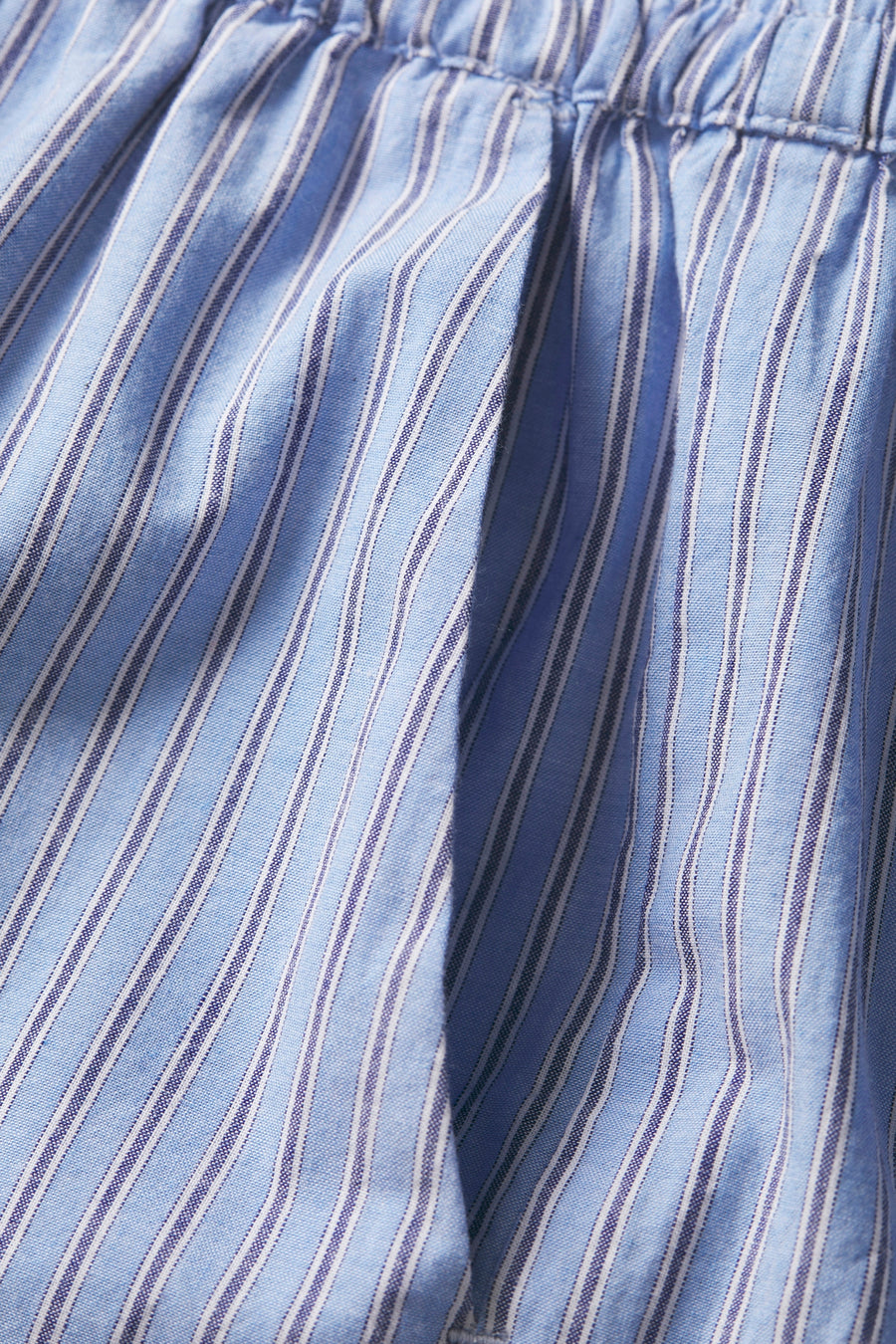 Gestreepte blauwe katoenen stof met elastische tailleband.