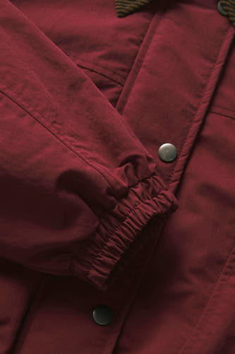 Manteau court rouge de JJXX, avec un bord de manche élastique et une fermeture à boutons.