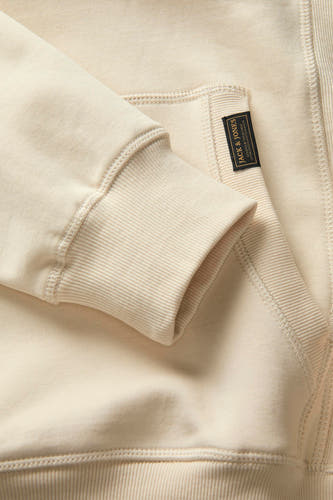 Gilet beige de PREMIUM BLUE par JACK & JONES, avec des bordures de manches côtelées et un étiquette sur la poche.