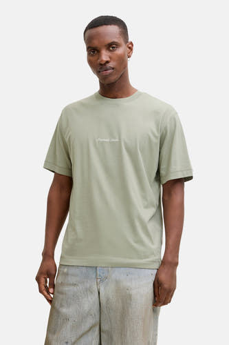 T-shirt vert à manches courtes ORIGINALS BY JACK & JONES, à manches courtes et coupe décontractée, porté avec un jean.