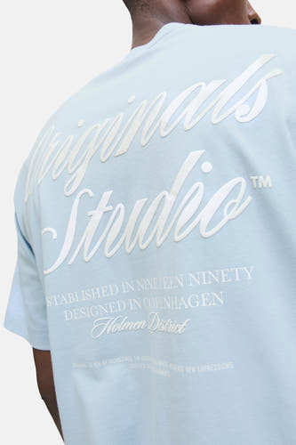 T-shirt bleu à manches courtes de ORIGINALS BY JACK & JONES, avec imprimé texte blanc au dos.