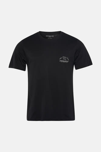 T-shirt noir à manches courtes de CORE BY JACK & JONES, avec un imprimé discret sur la poitrine, combiné avec un jean bleu.