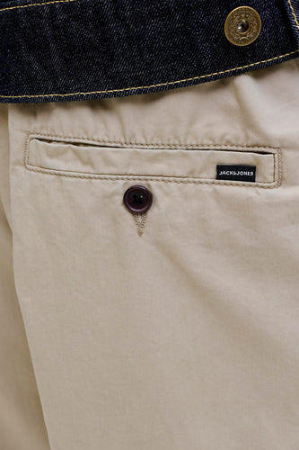 Beige broek met achterzak, donkerblauwe denim jas.