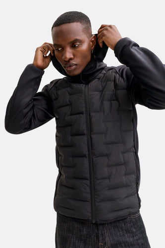 Man met zwarte gewatteerde jas en capuchon.